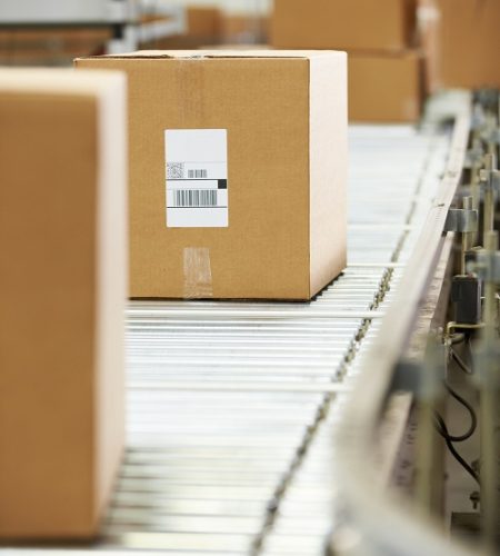 Goods On Conveyor Belt In Distribution Warehouse